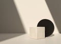 Cube shaped natural concrete or stone stand with black cylindrical podium and beige wall and shadow background Royalty Free Stock Photo