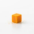 Cube-shaped object in bright orange, sitting on a clean white Royalty Free Stock Photo
