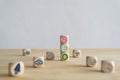 A cube-shaped wooden block sits on a desk with the word SEO