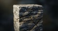 Cracked Stone Cube with Striated Gray and White Marble Texture and Sharp Edges on a Dark Blurred Background Royalty Free Stock Photo