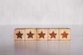 Cube wooden block with five star vote rating, review and feedback of quality and satisfaction.