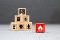 Cube wooden block stack with fire icon and door exit sing or fire escape with prevent icon