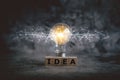 Cube word of IDEA and glowing light bulb with futuristic icon . Self learning or education knowledge and business studying concept Royalty Free Stock Photo