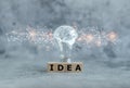 Cube word of IDEA and glowing light bulb with futuristic icon . Self learning or education knowledge and business studying concept Royalty Free Stock Photo