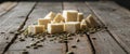 Cubed Cheese and Seeds on Wooden Surface. Royalty Free Stock Photo