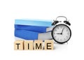 Cubes with alarm clock and stack of books Royalty Free Stock Photo