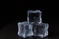 Cubes of clear ice on a black table