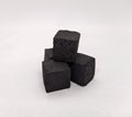Cubes of coconut coal for a hookah on a white background. Coal for shisha from coconut shell. Coconut charcoal for