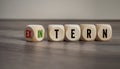 Cubes, dice or blocks showing the german words for external and internal - extern and intern on wooden background