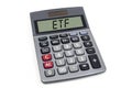 Cubes dice and calculator with etf on wooden background and laptop keyboard