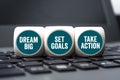 Cubes and dice with dream big, set goals and take action Royalty Free Stock Photo