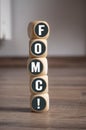 Cubes dice with FOMC Federal Open Market Committee on wooden background