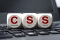 Cubes and dice on laptop keyboard with CSS cascading style sheets