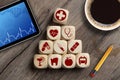 Cubes dice with tablet and medical symbols Royalty Free Stock Photo