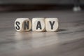 Cube and dice on wooden background with say and nay Royalty Free Stock Photo