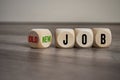 Cubes and dice on wooden background with word New Job versus old job Royalty Free Stock Photo