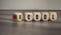 Cubes and dice with words cool and uncool on wooden background