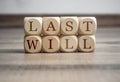 Cubes and dice with words last will on wooden background