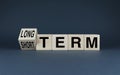 Cubes form words of choice Long term or short term. Concept of business investment and goals Royalty Free Stock Photo