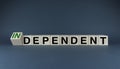 Cubes form the words Independent or dependent. The concept of independence in business, international relations and personal life