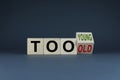 Cubes form words Too young or too old. Concept of age discrimination - social problem Royalty Free Stock Photo
