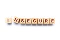 Cubes forming the word INSECURE Royalty Free Stock Photo