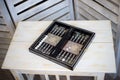 Cubes and game pieces on a backgammon board, on wooden table Royalty Free Stock Photo