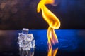 cubes of ice and fire on a water surface on an abstract background