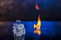 Cubes of ice and fire on a water surface on an abstract background Royalty Free Stock Photo