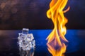 Cubes of ice and fire on a water surface on an abstract background Royalty Free Stock Photo