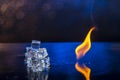 Cubes of ice and fire on a water surface on an abstract background Royalty Free Stock Photo