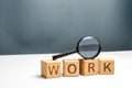 Cubes labeled work and magnifying glass. Concept of job search or workers. Human resources, hiring specialists and specialized Royalty Free Stock Photo