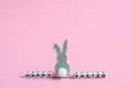 Cubes with letters and Easter bunny decor. Happy Easter inscription on pink background. Festive card for Easter