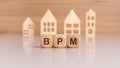 Cubes with message BPM surrounded by wood home Royalty Free Stock Photo