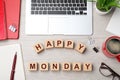 Cubes with message Happy Monday, office stationery and cup of coffee on wooden desk, flat lay Royalty Free Stock Photo