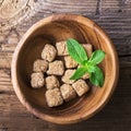 Cubes natural brown cane sugar in a wooden bowl on background. The concept of organic food. Selective focus. Royalty Free Stock Photo