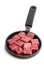 Cubes of raw beef meat on small frying pan isolated on white Royalty Free Stock Photo