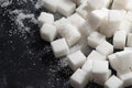 Cubes of refined sugar on a black table close-up Royalty Free Stock Photo