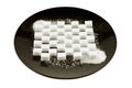 Cubes of refined sugar laid in a pattern on a black plate, cryst Royalty Free Stock Photo