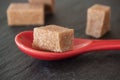 cubes of sugar in a red spoon on chalkboard backgroun Royalty Free Stock Photo