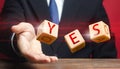 Cubes thrown by a man make up word YES. Agreement and acceptance, answer the question. Confirmation and approval. Important Royalty Free Stock Photo