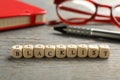 Cubes with word Blacklist and office stationery on grey wooden desk, closeup Royalty Free Stock Photo