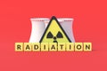 Cubes with word radiation near sign of toxic hazard and nuclear power plant on red background