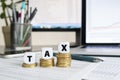 Cubes with the word Tax on stacks of coins. Royalty Free Stock Photo