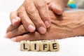 Cubes with the words life on the background of the hands of an e Royalty Free Stock Photo