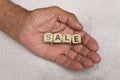 Cubes with the words SALE in the hands of an elderly person. The concept of sale Royalty Free Stock Photo