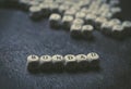 Wooden cubes with letters on a black background forming the word kindness Royalty Free Stock Photo