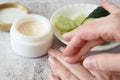 Cucumber cosmetic cream face and hand on gray background, skin and body care hygiene moisture lotion