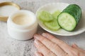 Cucumber cosmetic cream face and hand on gray background, skin and body care hygiene moisture lotion