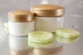 Cucumber cosmetic cream face and hand on silver background, skin and body care lotion
